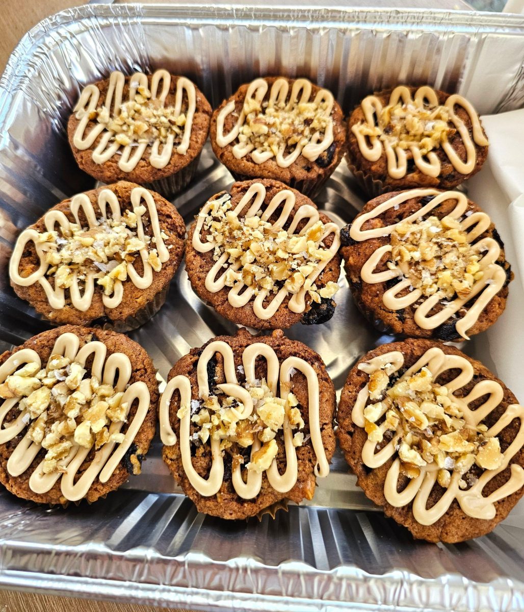vegan spice muffins topped with brown sugar frosting and chopped nuts